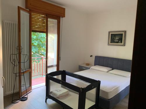 a bedroom with a bed and a balcony at A Casa di Vanna in Montese