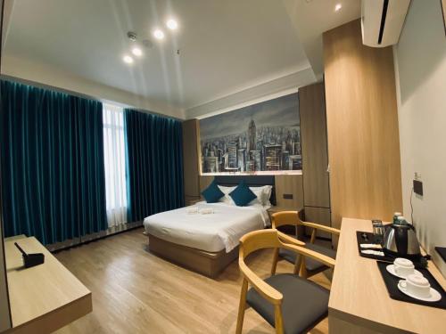 a hotel room with a bed and a desk at Fan's Hotel Palo in Tacloban