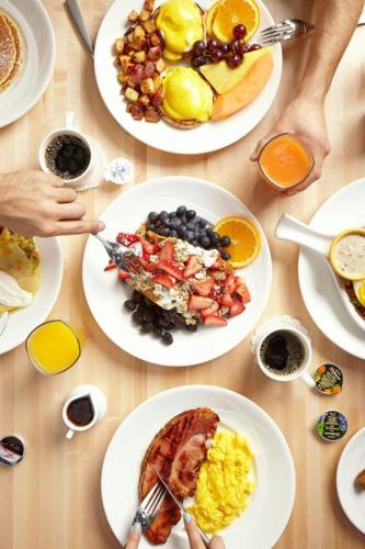a table with plates of breakfast food on it at Hotel Chicago Downtown, Autograph Collection in Chicago