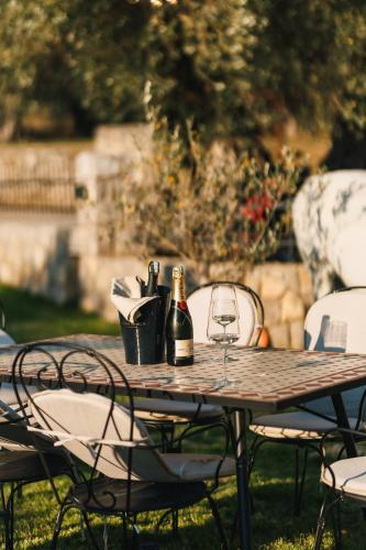 a table with a bottle of wine and a glass at CAROLEA VILLAS in Ulcinj