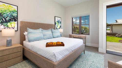 a bedroom with a bed with a tray on it at ❤PiH❤ Hale Moana Heated Private Pool Spa Detached Ohana Suite in Waimea