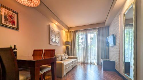 a living room with a table and a couch at Luxury Dreamland Oasis Apartments in Chakvi