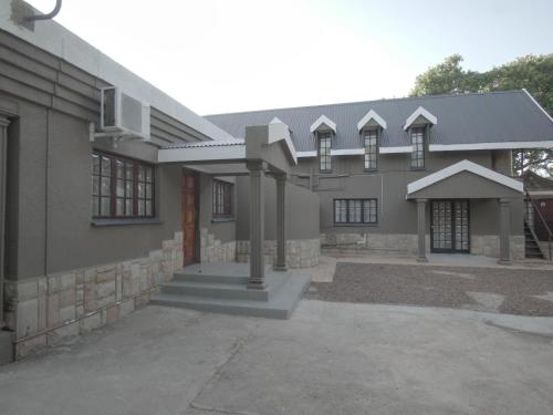 a large house with a driveway in front of it at Insolam Accommodation in Mokopane