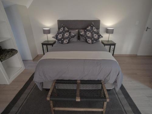 a bedroom with a large bed with two tables at Insolam Accommodation in Mokopane