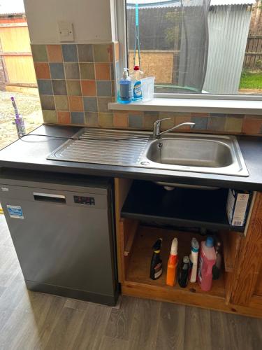 a kitchen with a sink and a counter top at 3 Bedroom Family home in Limavady