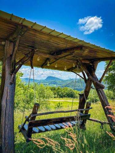 a bench chained to a wooden structure in a field at Cabana Arunia in Buninginea
