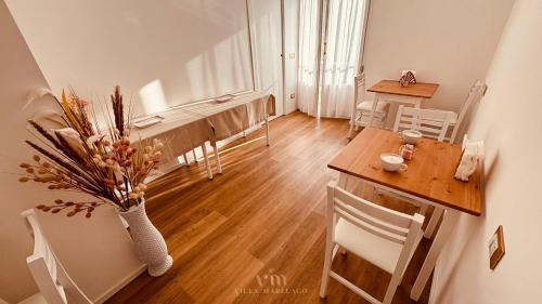 a living room with a table and a dining room at Villa Marelago Guest House in Lido Di Fondi