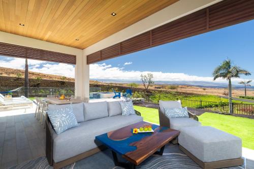 a living room with a couch and a table at BLUE SERENITY Luxurious home in private community with Heated Private Pool Spa Detached Ohana Suite in Waimea