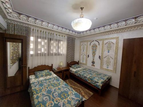 Кровать или кровати в номере Hotel Gulnaraxanum Boutique This hotel is nearby the center of the old city Every room decorated in the unique style
