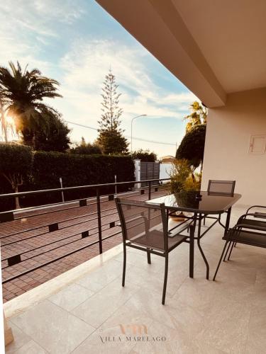 a patio with a table and chairs on a balcony at Villa Marelago Guest House in Lido Di Fondi