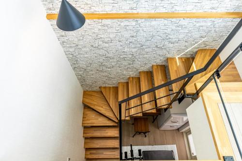 a staircase in a building with a light fixture at Laguna Fuchaku in Onna