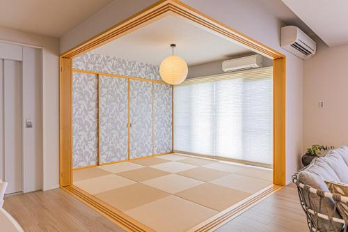 a room with a large glass door with a checkerboard floor at Laguna Fuchaku in Onna