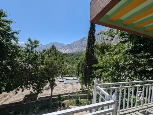 a balcony of a house with a view of the mountains at The Jade Palace, Hunza in Karimabad Hunza