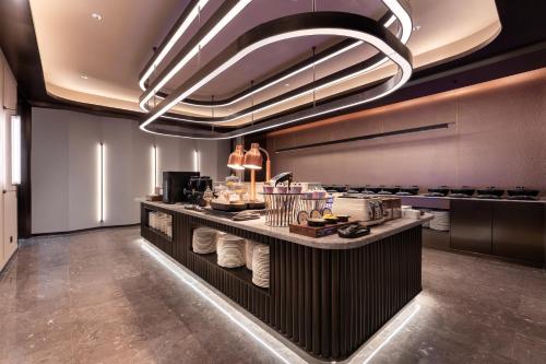 a kitchen with a counter with food on it at Crystal Orange Hotel Zhuhai Gongbei Port in Zhuhai