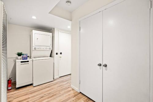 a kitchen with a refrigerator and a washer and dryer at 1 Block to Beach Heaven Chic 2BD in Manhattan Beach