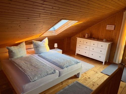 a bedroom with a bed and a skylight at Ferienhaus SONNE in Hohnstein