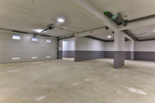 an empty parking garage with metal garage doors at Bar- Apartment Prestige in Bjeliši