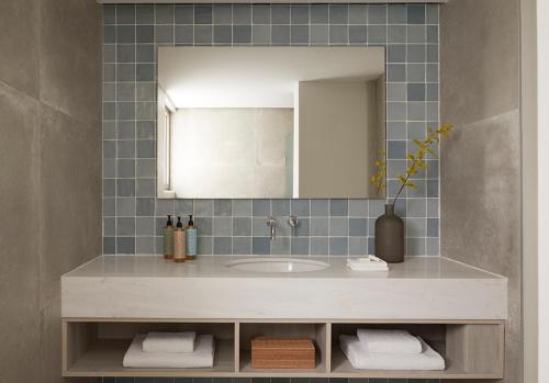 a bathroom with a sink and a mirror at Mare Paphos in Paphos