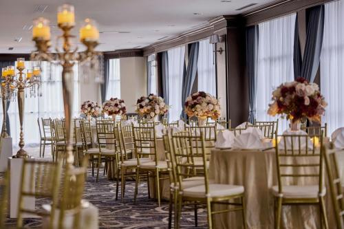 a room filled with tables and chairs with flowers at AC Hotel by Marriott Ipoh in Ipoh