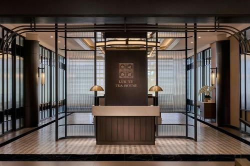 a lobby with a reception desk in a building at AC Hotel by Marriott Ipoh in Ipoh
