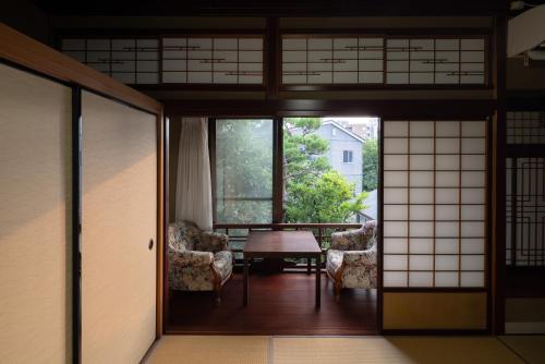 a room with two chairs and a table at Ichirin Kanazawa in Kanazawa