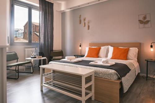 Un dormitorio con una cama grande con almohadas naranjas. en MILANO 71 HOME, en Milán