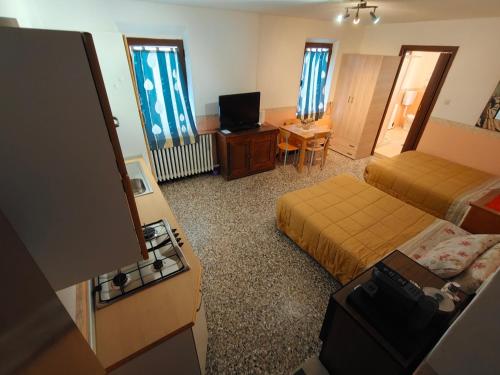 a hotel room with two beds and a desk at Parco Gessilandia in Sassofeltrio