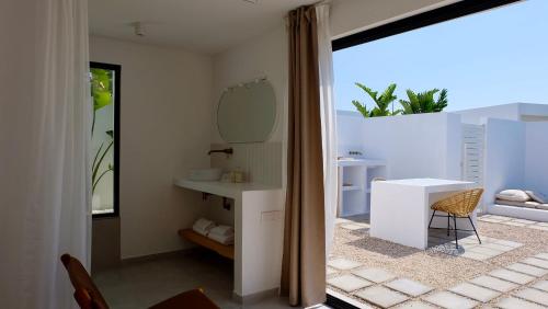 a bathroom with a white sink and a mirror at EBLI7 Hotel Boutique in Orihuela Costa