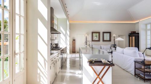 a living room with a white couch and a table at Luxurious Beachfront Villa in Flamands in Anse des Flamands
