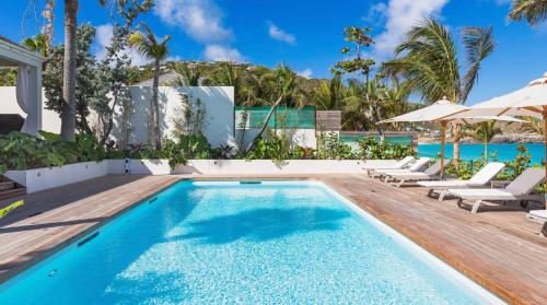 an image of a swimming pool at a resort at Luxurious Beachfront Villa in Flamands in Anse des Flamands