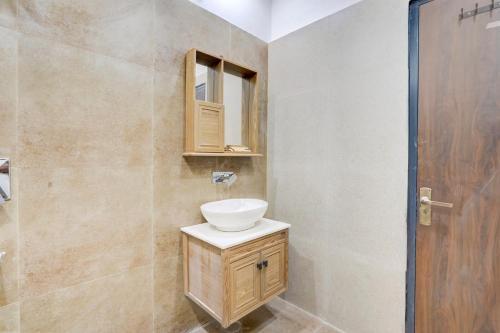 a bathroom with a sink and a mirror at Alaya Stays Fortezza Pet-friendly 6-BHK Farmhouse With Private Pool, Gazebo & Lush Garden in Bhundsi