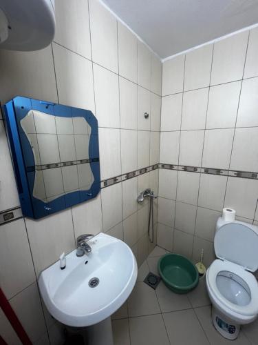 a bathroom with a sink and a toilet at Hotel PEJA in Velipojë