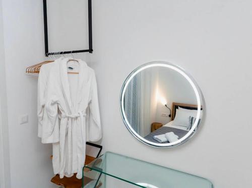 a mirror hanging on a wall next to a bedroom at Sunny Nest Apartments in Ixia