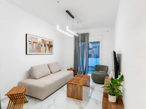 a living room with a couch and a chair at Sunny Nest Apartments in Ixia