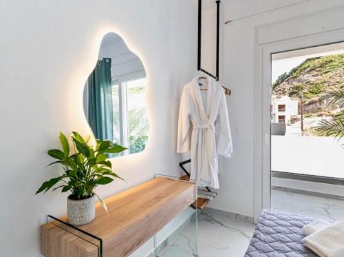 a dressing room with a mirror and a plant at Sunny Nest Apartments in Ixia