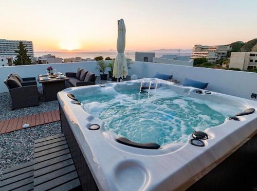 a jacuzzi tub sitting on top of a rooftop at Sunny Nest Apartments in Ixia