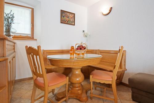a dining room table and chairs in a room at Hiška Kovačija in Vremski Britof