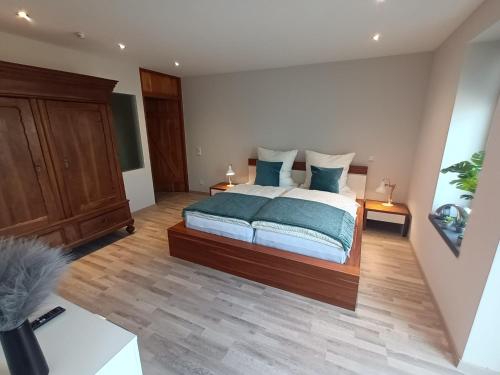 a bedroom with a large bed with blue pillows at Flammerie - Hoferstraße 30c in Gangelt