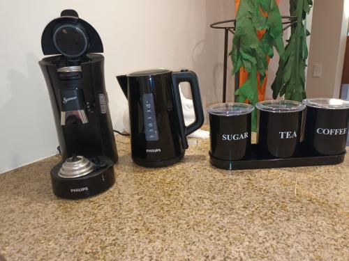 a coffee maker and two cups on a counter at Flammerie - Hoferstraße 30c in Gangelt