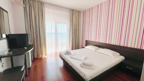 En eller flere senge i et værelse på Vila Sunrise Costinesti