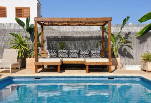 a swimming pool with a gazebo next to a swimming pool at Villa in Playa den Bossa, 5 min SupermarketBBQ in Sant Jordi