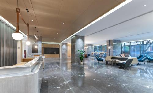 a lobby of a building with chairs and tables at Holiday Inn Express Lijiang Ancient Town by IHG in Lijiang