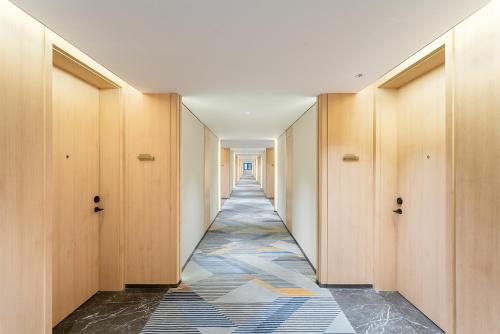 a hallway with wooden doors and a tile floor at Holiday Inn Express Lijiang Ancient Town by IHG in Lijiang