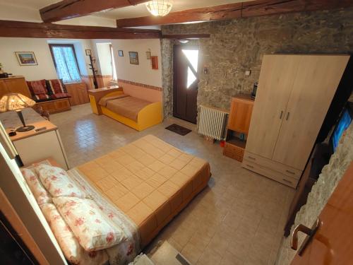 a bedroom with a bed and a couch in a room at Parco Gessilandia in Sassofeltrio