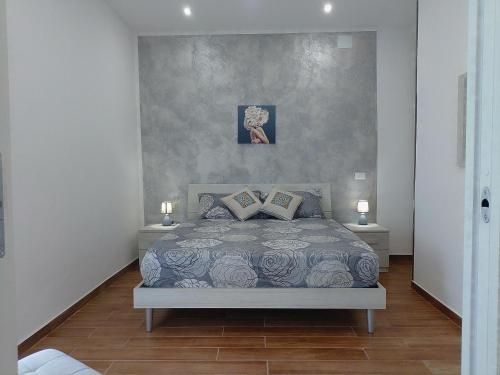a bedroom with a bed with two nightstands and two lamps at Chiara BeachSuite in Palermo