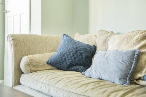 a couch with pillows on it in a living room at Ladybird House in Loughborough