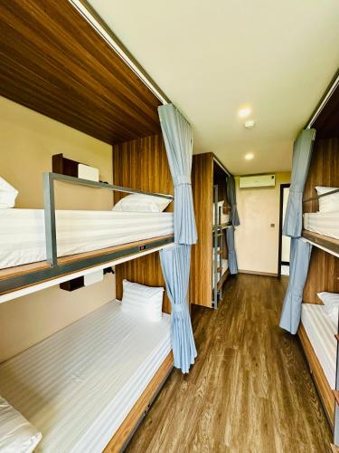 a room with three bunk beds in a hostel at NinhBinh Buffalo Hostel in Vũ Lâm