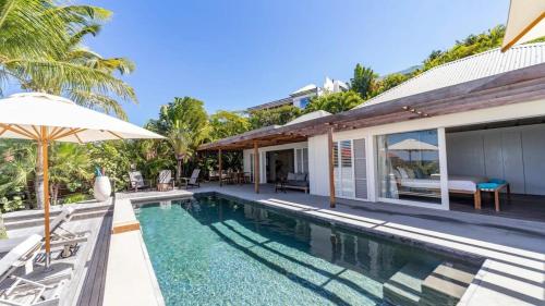 a villa with a swimming pool and a house at Luxury Villa with Ocean View in St Barts in Saint-Jean