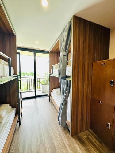 a dorm room with bunk beds and a balcony at NinhBinh Buffalo Hostel in Vũ Lâm