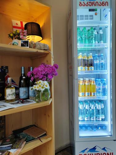 an open refrigerator filled with bottles of water at Hotel Svanseti in Mestia